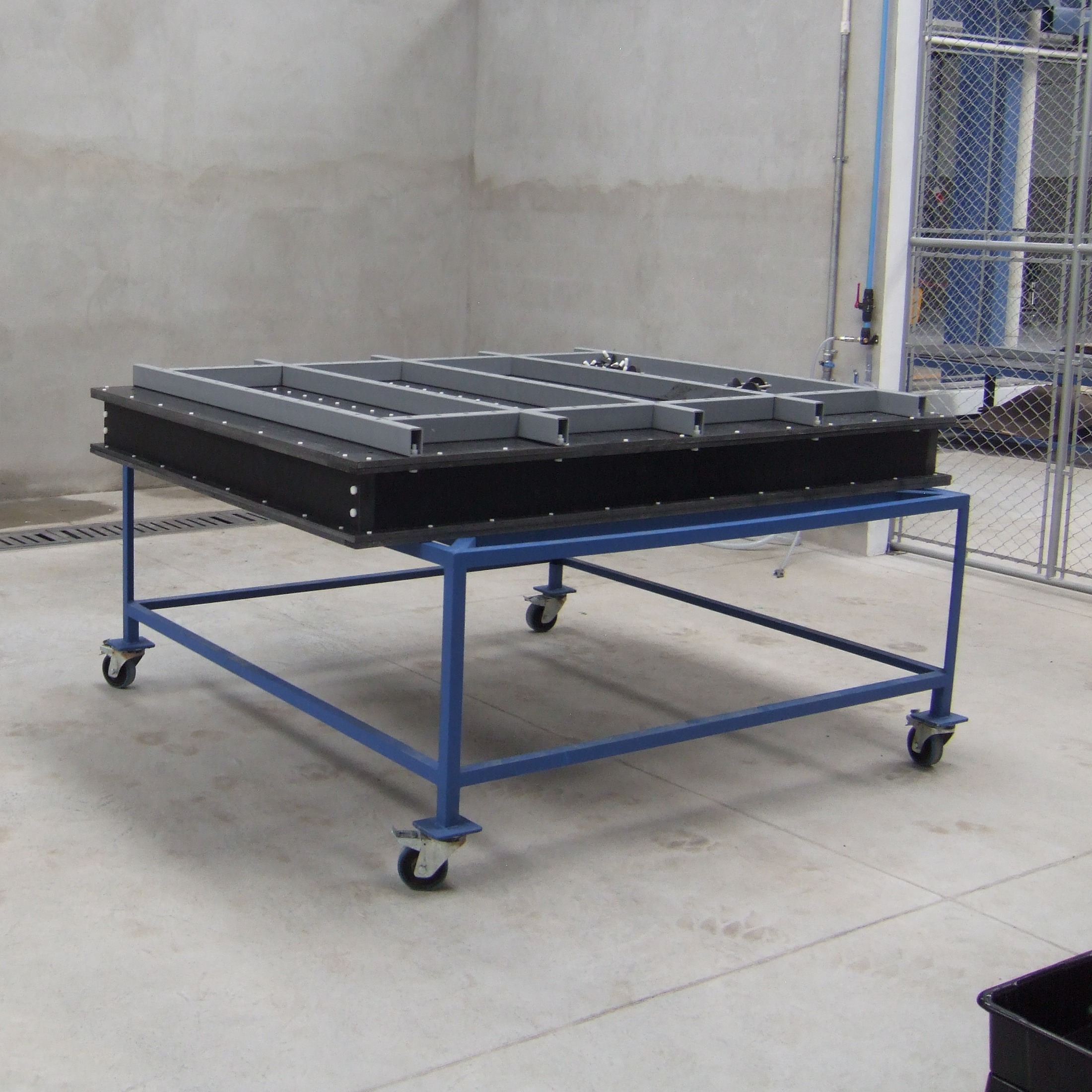Early lightweight mobile mold cart prototype on wheels, in a Guatemala workshop