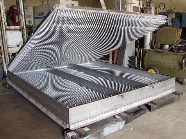 Open conventional steam-vulcanization pin-mold, showing the dense pin pattern across the full panel